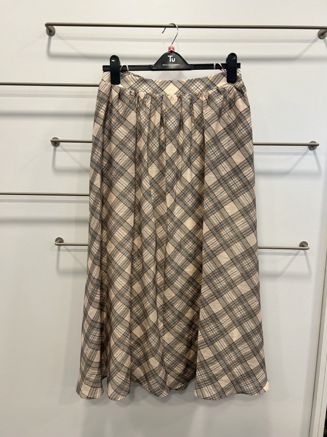 Skirt photographed against shop rails instead of a white background