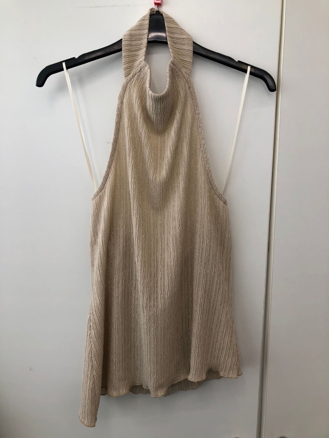 Halter top photographed without steaming on an unsuitable hanger, with the rail visible in the frame